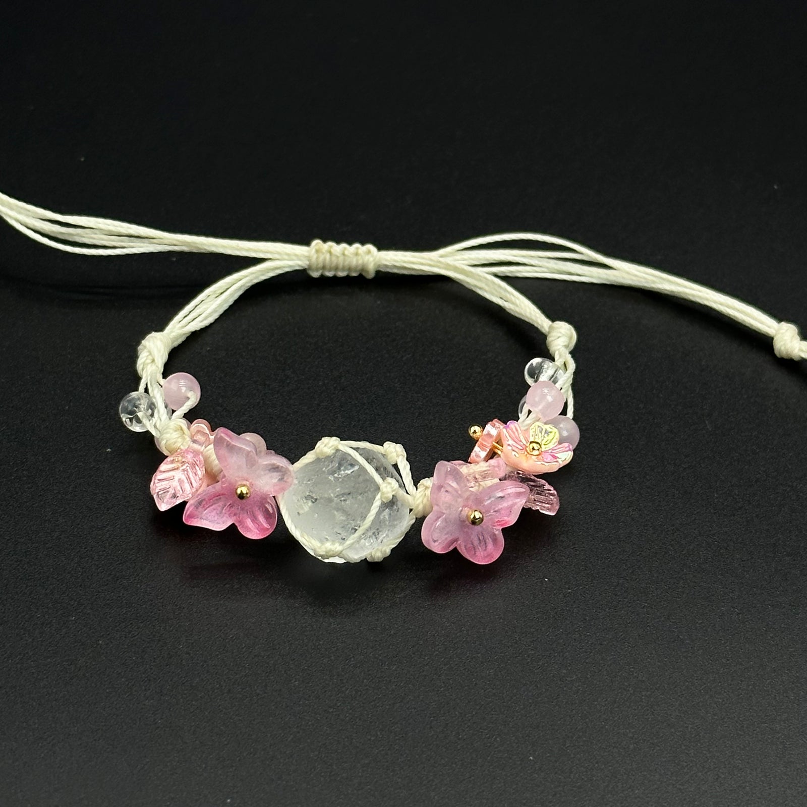 Rose Garden bracelet with pink and mixed-color crystal blossoms on a hand-braided cord