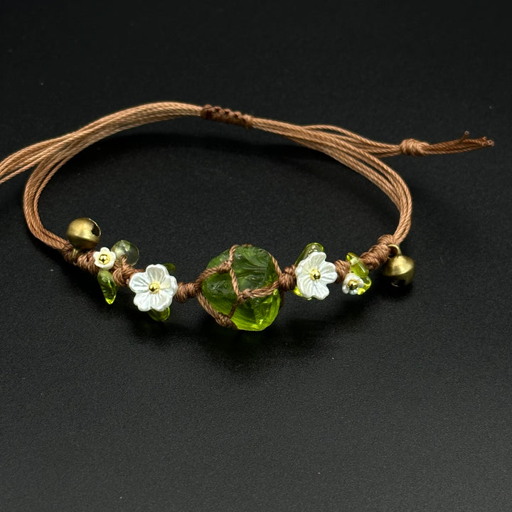 Woodland Quartz bracelet with green leaf-inspired details and quartz accents on a braided cord