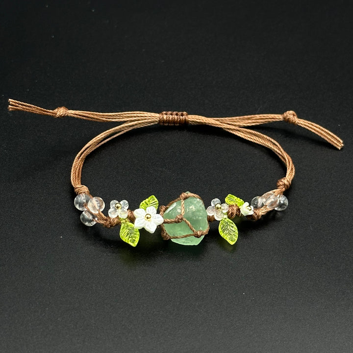 Honey Fern bracelet with warm green and golden leaf-inspired accents on a braided cord