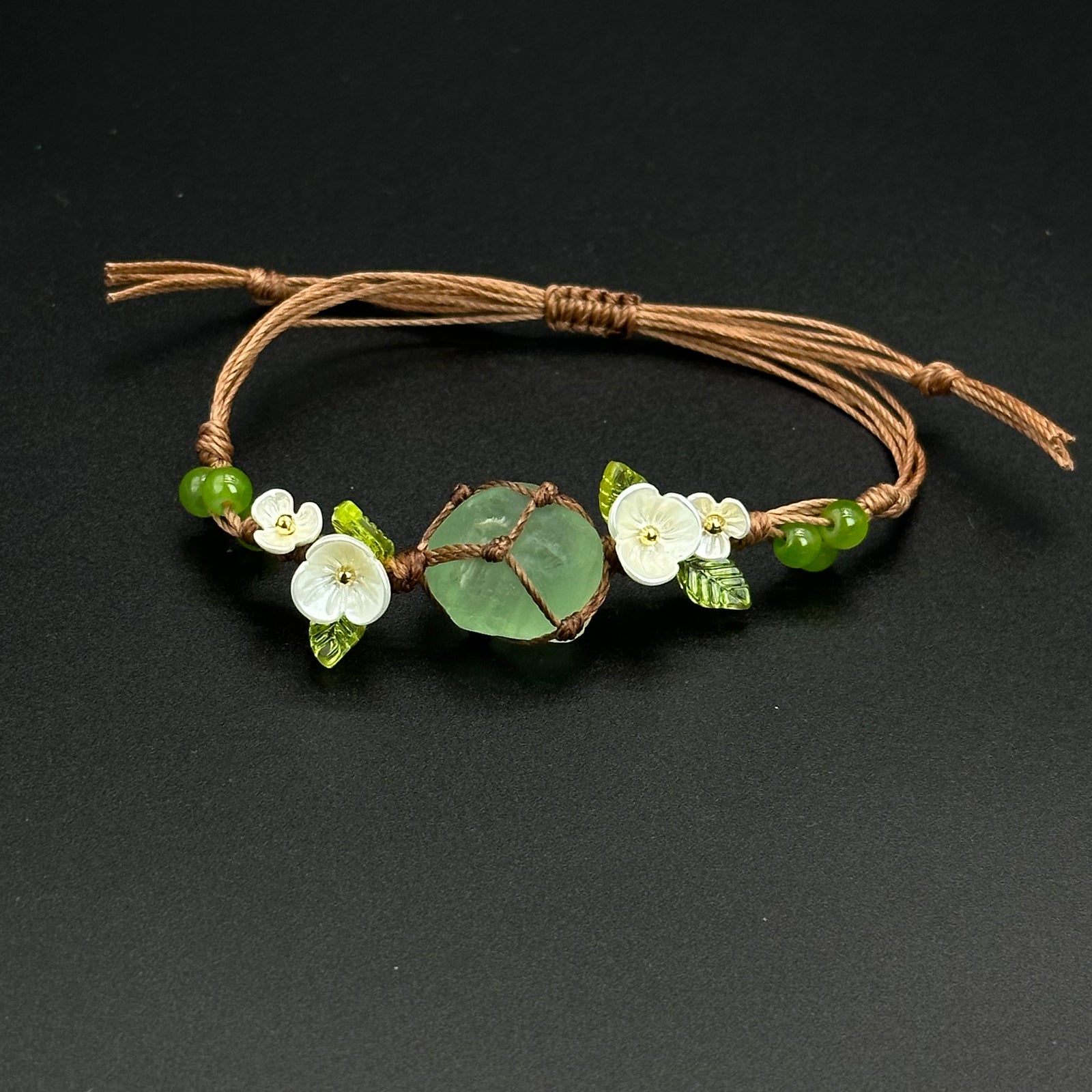 Earthbound Green bracelet with grounded green leaf-inspired crystal accents on a braided cord
