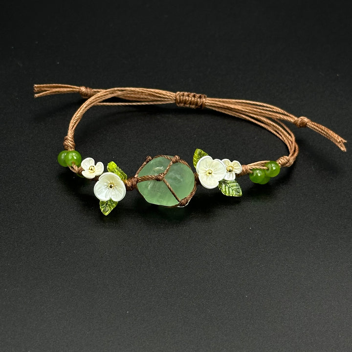 Earthbound Green bracelet with grounded green leaf-inspired crystal accents on a braided cord
