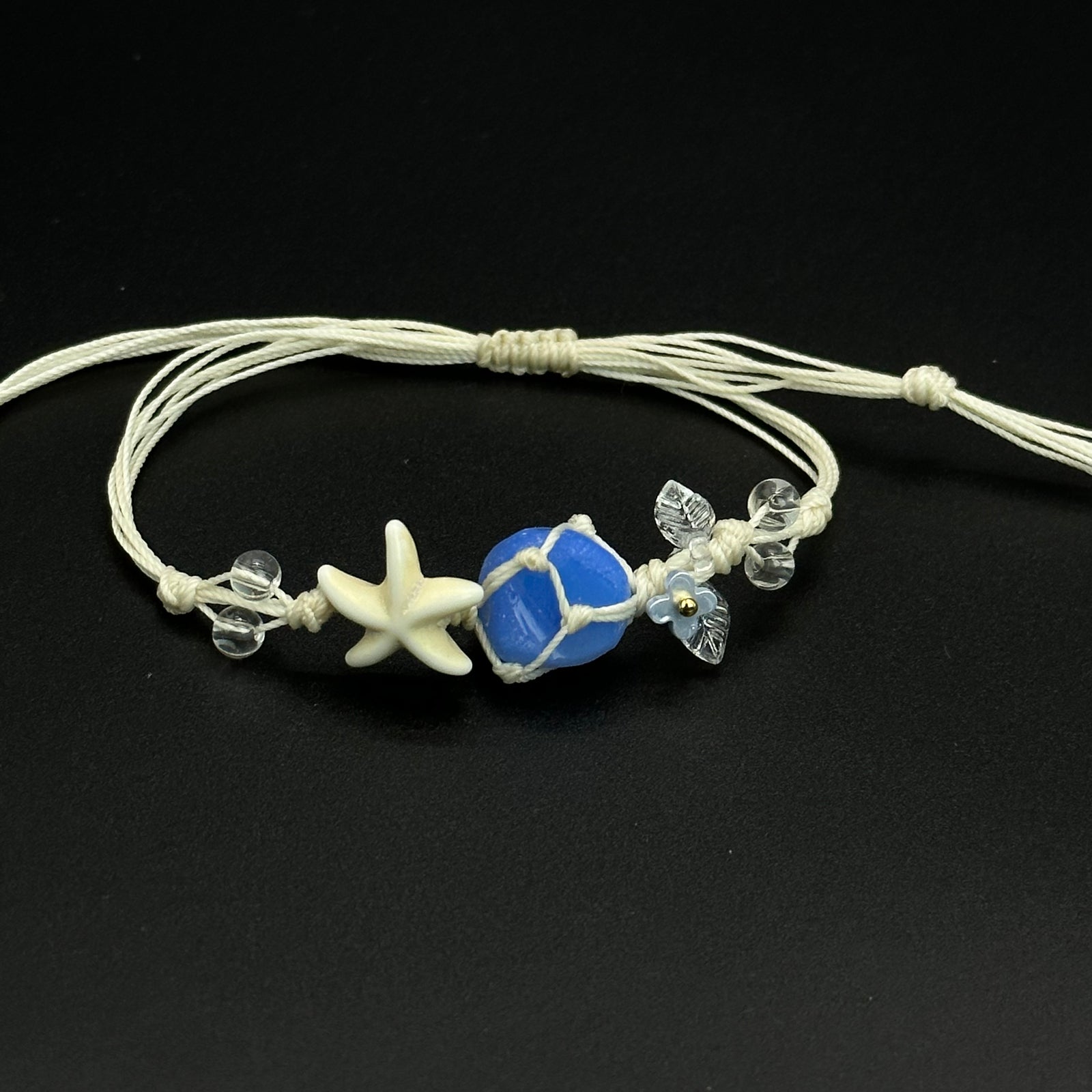 Sapphire Star bracelet with deep blue and mixed-color blossom crystals on a braided cord
